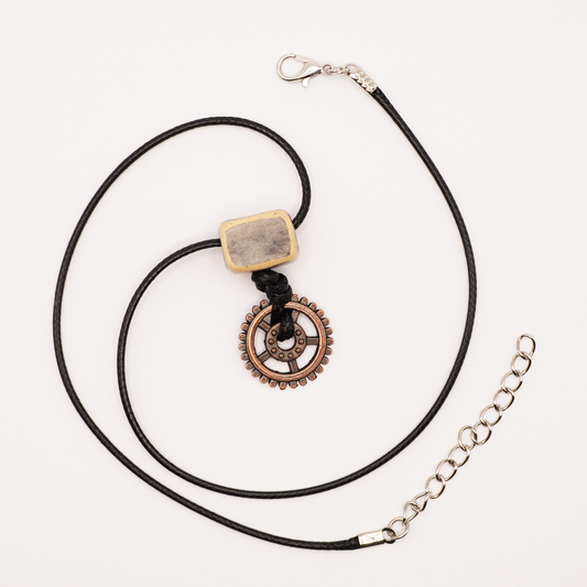 Necklace with a gear pendant on a white background