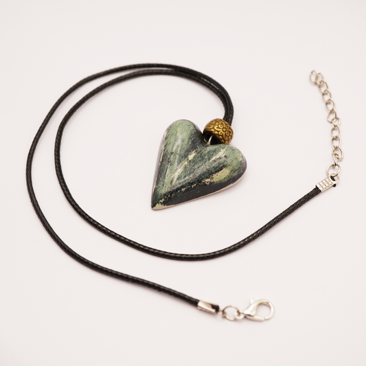 Necklace with a heart-shaped stone pendant on a white background