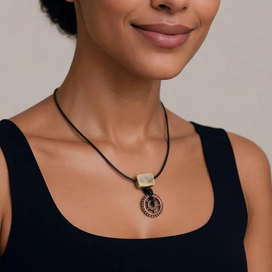 Woman wearing a necklace with a pendant against a neutral background