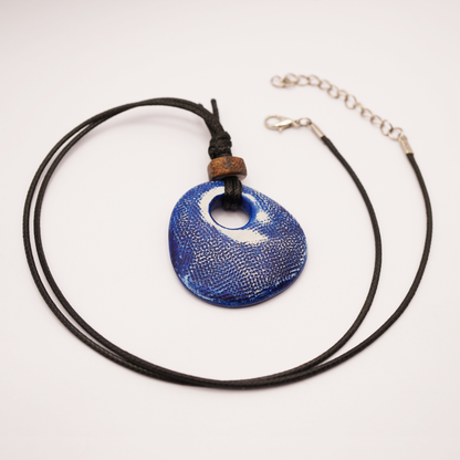 Necklace with a blue pendant on a white background