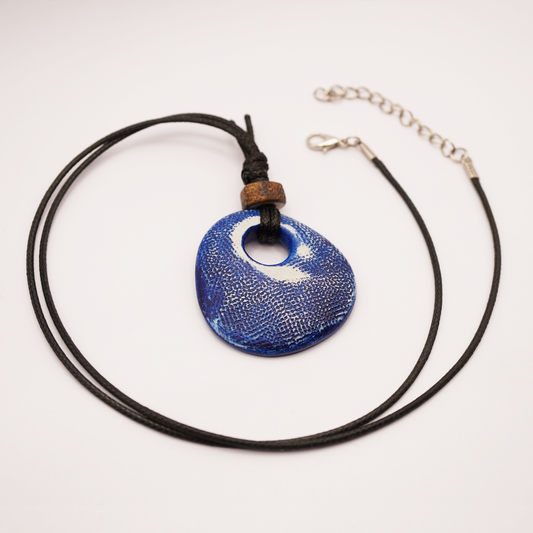 Necklace with a blue pendant on a white background