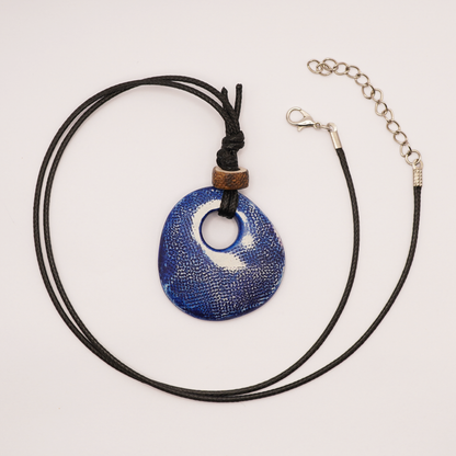 Necklace with a blue pendant on a light gray background