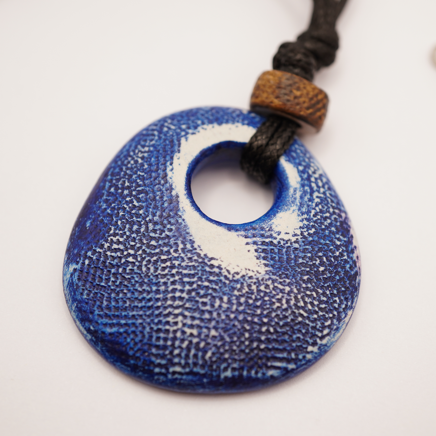 Blue textured pendant on a white background