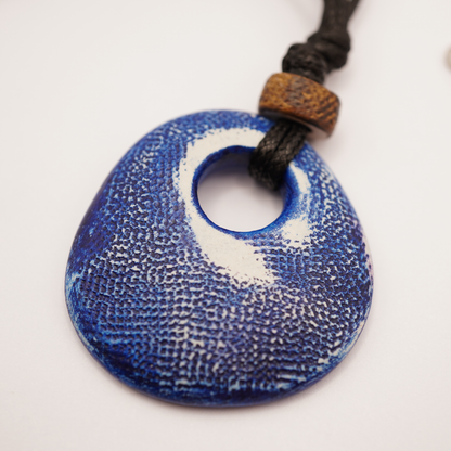 Blue textured pendant on a white background