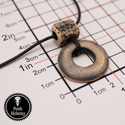 Handmade ceramic ring pendant with a textured square bead shown on a measurement grid with Punk Alchemy logo.