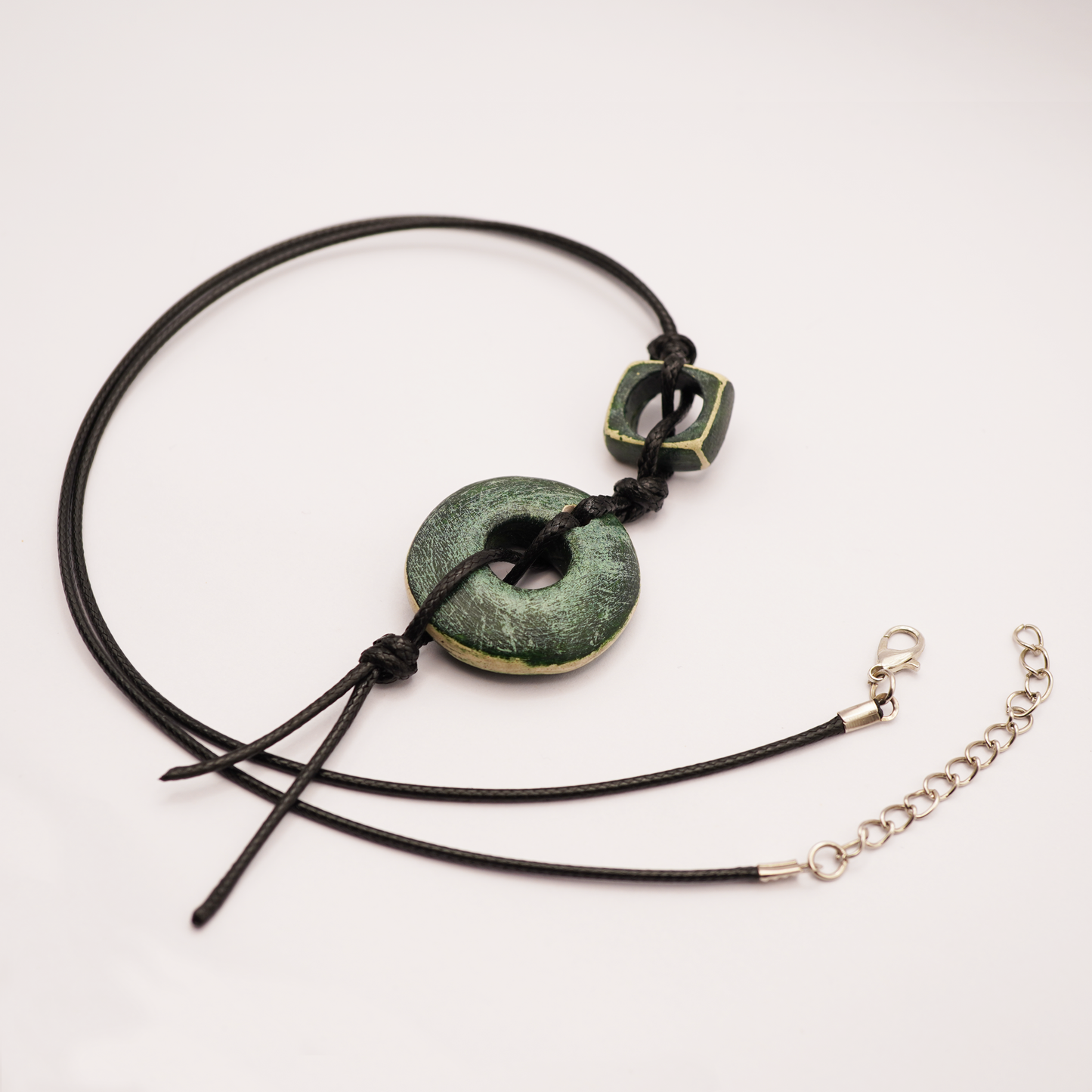 Necklace with green stone pendant on a white background