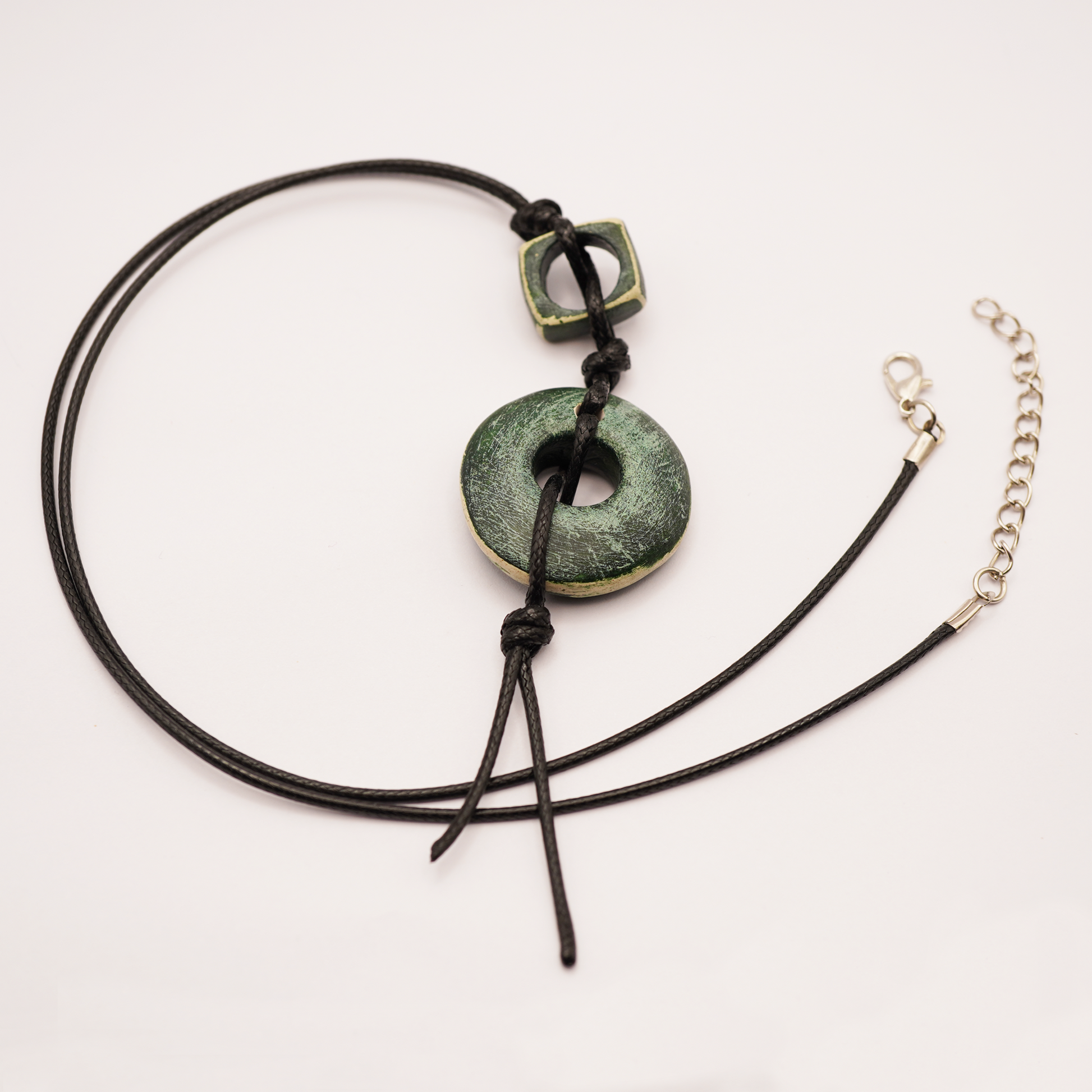 Necklace with green stone pendant on a white background