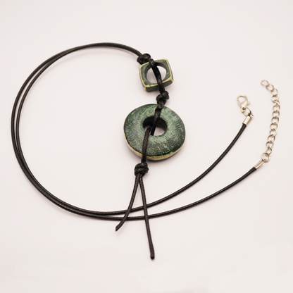 Necklace with green stone pendant on a white background