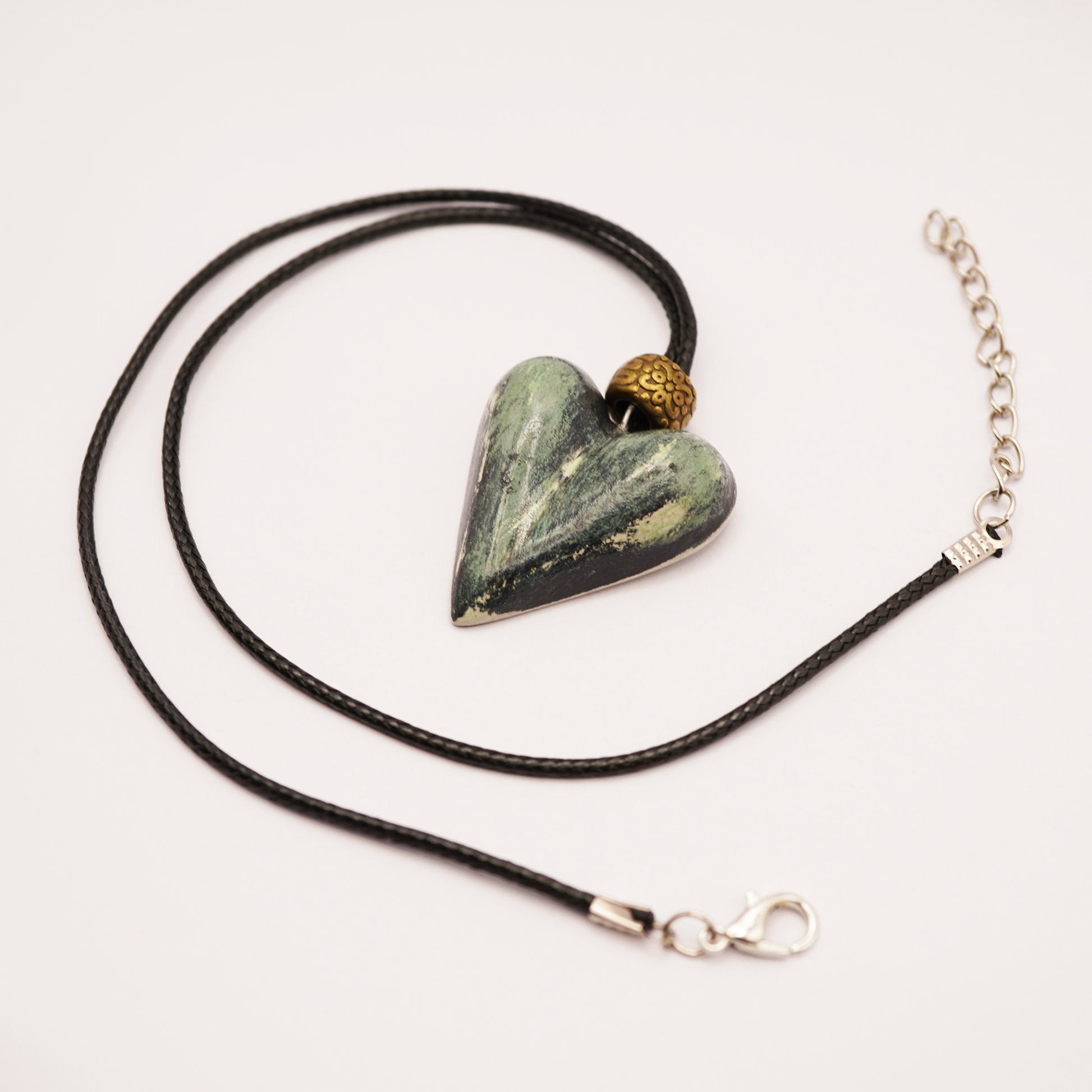 Necklace with a heart-shaped stone pendant on a white background